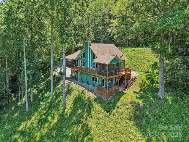 332 Mystic Cv, Waynesville, NC 28785 - rear view of property with a wooden deck, a chimney, a forest view, stairs, and a lawn