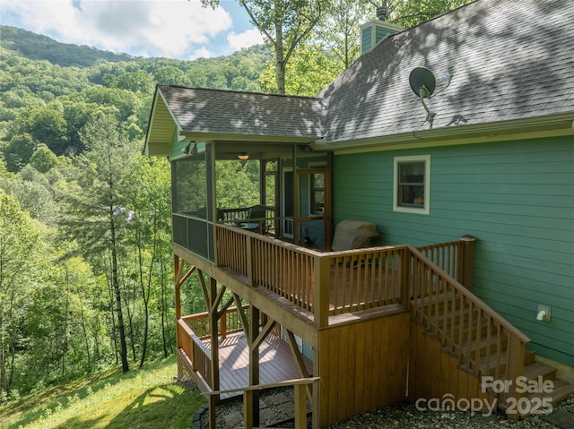 332 Mystic Cv, Waynesville, NC 28785 - deck with a sunroom, stairs, and a view of trees
