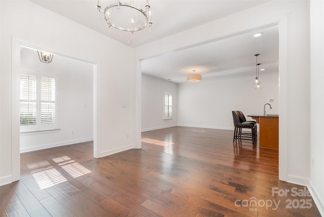6033 Bountiful St Unit 201, Belmont, NC 28012 - unfurnished living room with a chandelier, dark wood-style flooring, baseboards, and a sink
