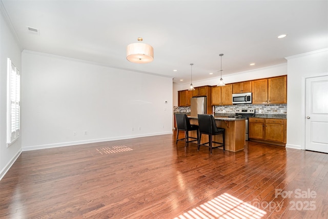 6033 Bountiful St Unit 201, Belmont, NC 28012 - kitchen with brown cabinetry, stainless steel appliances, ornamental molding, a breakfast bar area, and dark wood-style floors