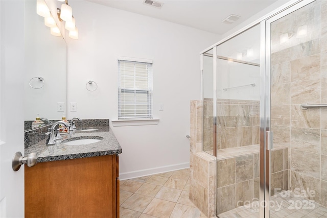 6033 Bountiful St Unit 201, Belmont, NC 28012 - bathroom with double vanity, a stall shower, tile patterned floors, and baseboards