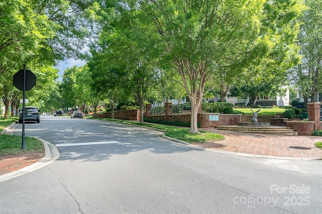 6033 Bountiful St Unit 201, Belmont, NC 28012 - view of asphalt road with curbs, sidewalks, and traffic signs
