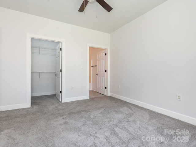 8747 Coralbell Ln, Charlotte, NC 28213 - unfurnished bedroom with carpet flooring, baseboards, a spacious closet, and ceiling fan