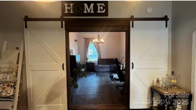 interior space with a barn door and wood finished floors