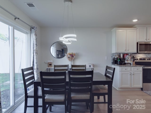 3322 Brighton Dr, Gastonia, NC 28052 - dining room featuring a chandelier, light wood-style flooring, and recessed lighting