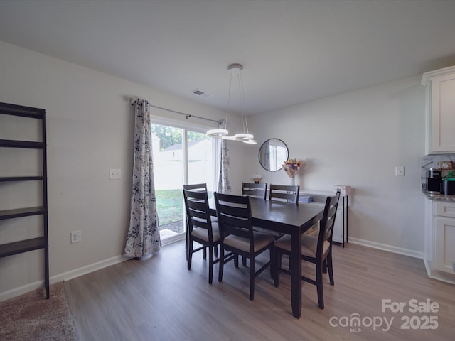 3322 Brighton Dr, Gastonia, NC 28052 - dining area with light wood finished floors, baseboards, and a chandelier