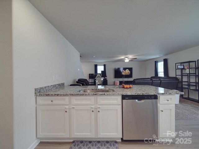 3322 Brighton Dr, Gastonia, NC 28052 - kitchen featuring stainless steel dishwasher, open floor plan, a sink, and light wood finished floors