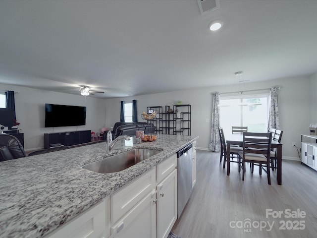 3322 Brighton Dr, Gastonia, NC 28052 - kitchen with a sink, stainless steel dishwasher, white cabinets, light wood finished floors, and a ceiling fan