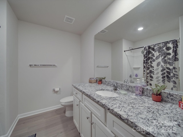 3322 Brighton Dr, Gastonia, NC 28052 - bathroom featuring baseboards, toilet, wood finished floors, vanity, and curtained shower