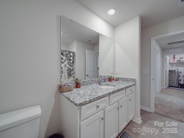 3322 Brighton Dr, Gastonia, NC 28052 - full bath featuring wood finished floors, toilet, vanity, and baseboards