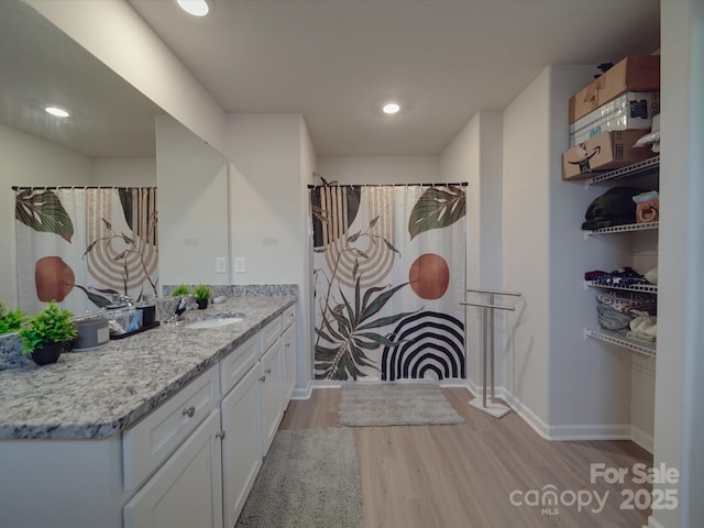 3322 Brighton Dr, Gastonia, NC 28052 - bathroom with wood finished floors, baseboards, vanity, and recessed lighting