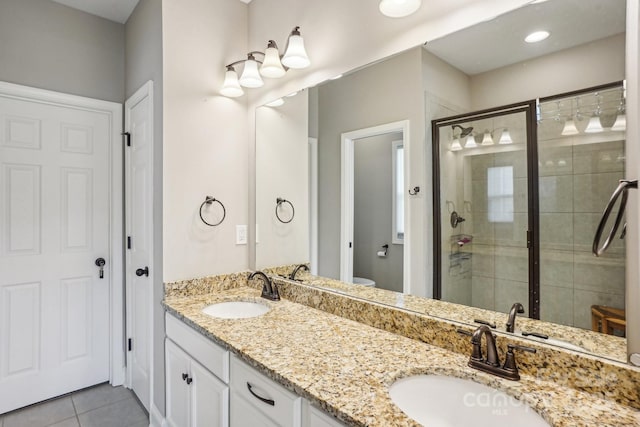 21610 Rio Oro Dr, Cornelius, NC 28031 - full bathroom with a stall shower, tile patterned floors, double vanity, and toilet