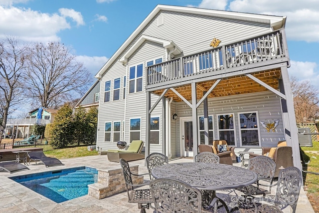 21610 Rio Oro Dr, Cornelius, NC 28031 - back of house featuring a patio, an outdoor pool, and outdoor dining space