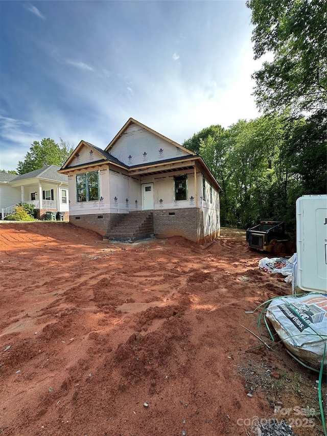 rear view of house with crawl space