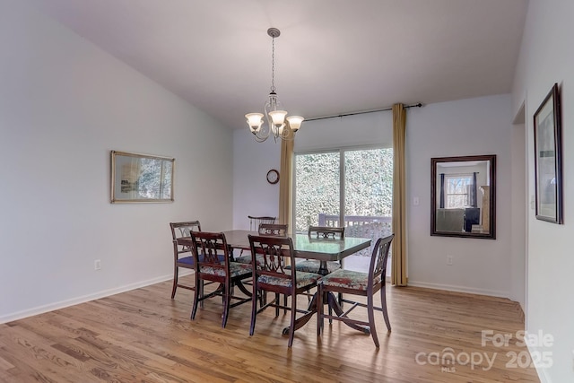 703 Cinnamon Way, Flat Rock, NC 28731 - dining room featuring light wood-style floors, a chandelier, baseboards, and vaulted ceiling