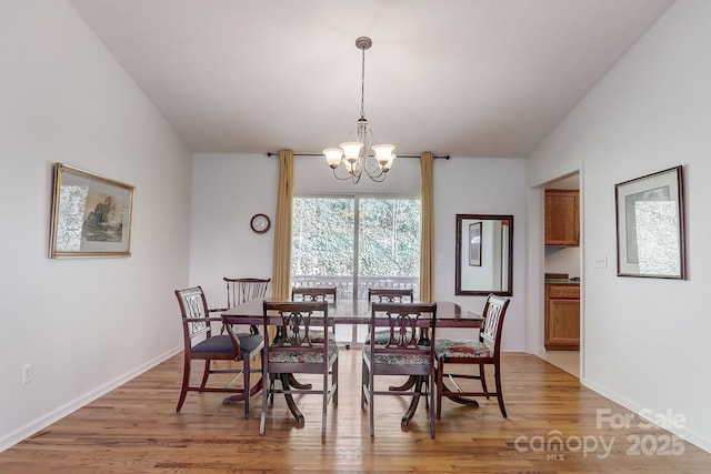 703 Cinnamon Way, Flat Rock, NC 28731 - dining area featuring a chandelier, light wood-style floors, and baseboards