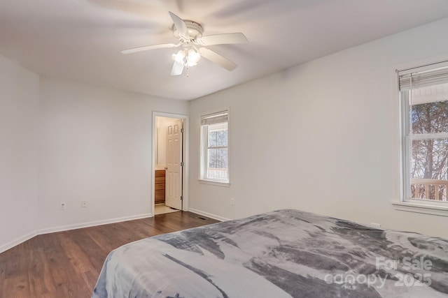 703 Cinnamon Way, Flat Rock, NC 28731 - bedroom with multiple windows, baseboards, and dark wood-style flooring