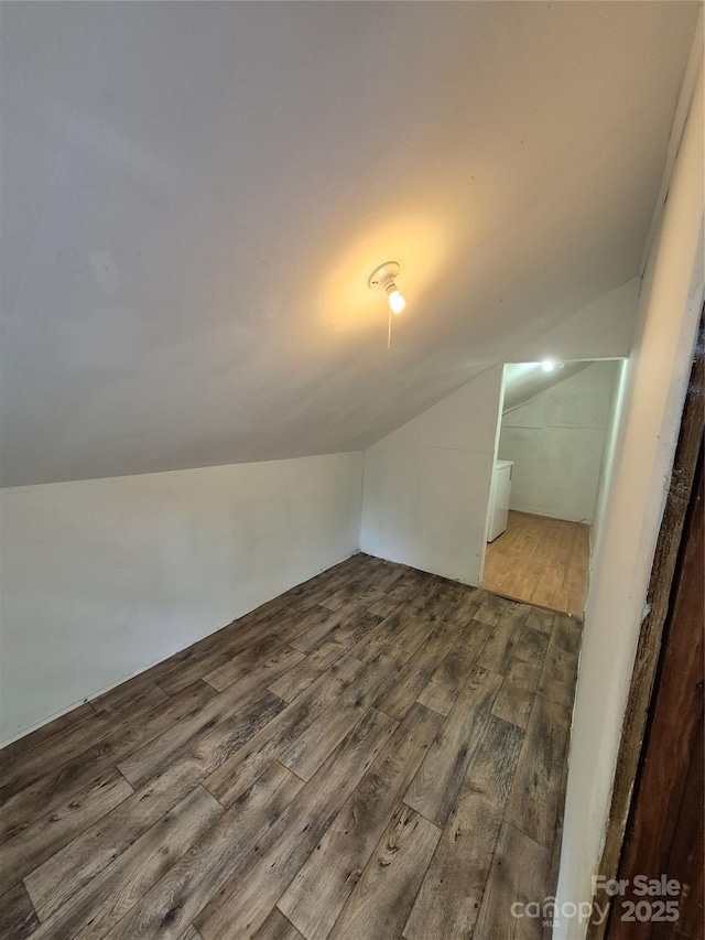additional living space with lofted ceiling and wood finished floors