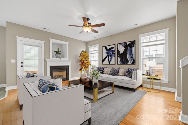 132 E Morehouse Ave, Mooresville, NC 28117 - living area with ceiling fan, a glass covered fireplace, light wood-style flooring, and baseboards