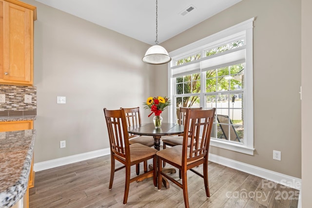 132 E Morehouse Ave, Mooresville, NC 28117 - dining area featuring baseboards and light wood-style floors