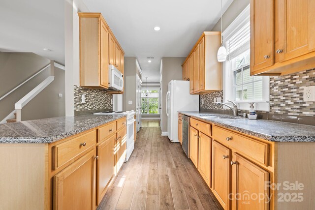 132 E Morehouse Ave, Mooresville, NC 28117 - kitchen with white appliances, a sink, light wood finished floors, decorative backsplash, and dark stone countertops