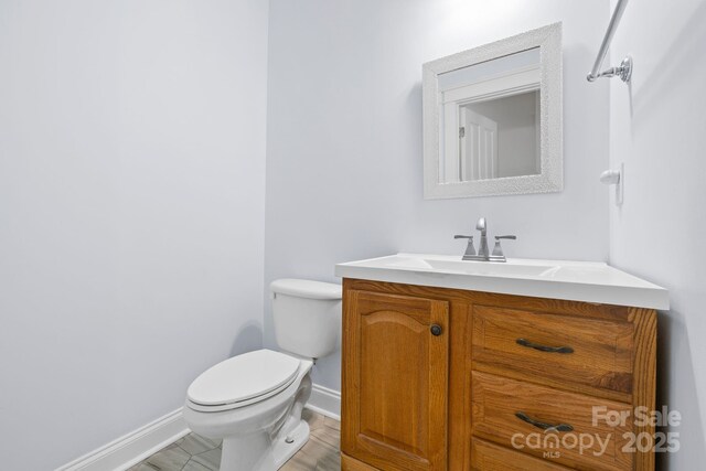132 E Morehouse Ave, Mooresville, NC 28117 - bathroom with toilet, baseboards, and vanity