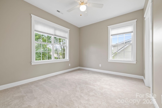 132 E Morehouse Ave, Mooresville, NC 28117 - spare room featuring light carpet, baseboards, and ceiling fan