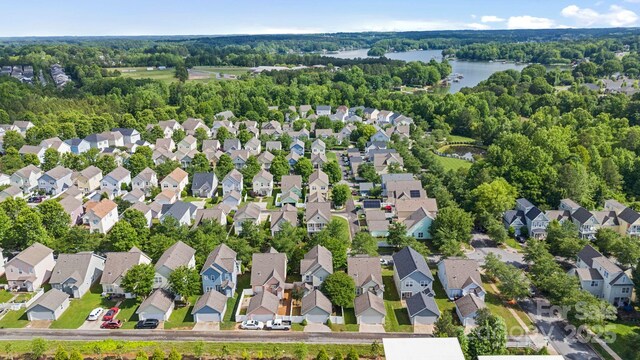 132 E Morehouse Ave, Mooresville, NC 28117 - aerial view of property's location featuring a large body of water, nearby suburban area, and a forest