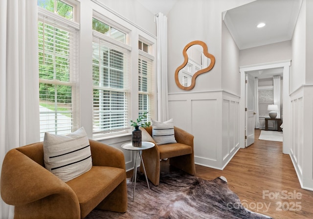 434 Breezewood Dr, Belmont, NC 28012 - living area with wood finished floors, a decorative wall, and wainscoting