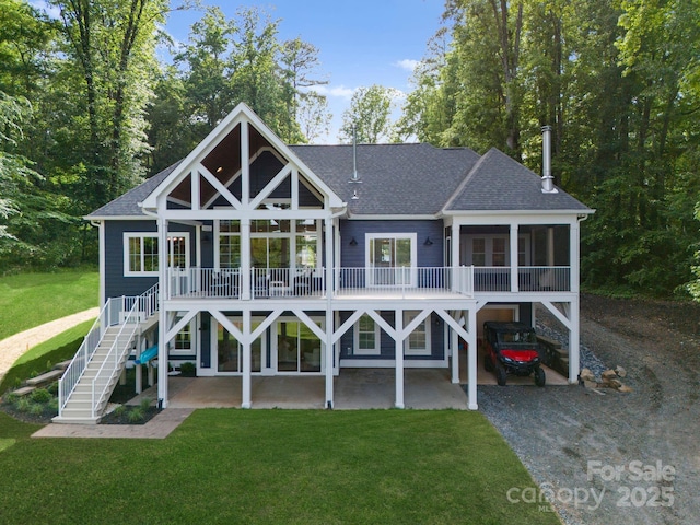 434 Breezewood Dr, Belmont, NC 28012 - rear view of house featuring stairway, a yard, roof with shingles, a sunroom, and gravel driveway