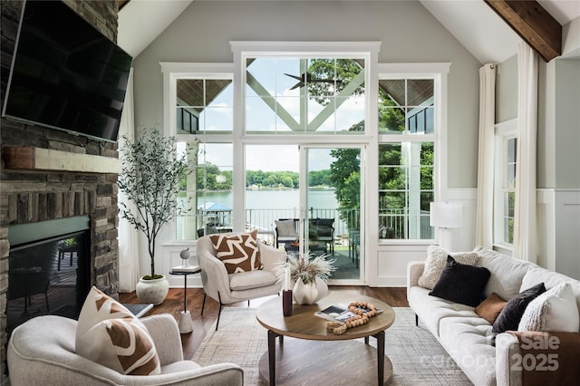 434 Breezewood Dr, Belmont, NC 28012 - living room with vaulted ceiling, a water view, wood finished floors, a fireplace, and plenty of natural light
