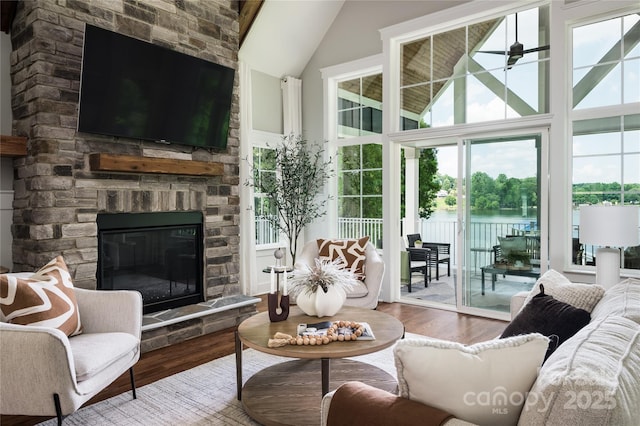 434 Breezewood Dr, Belmont, NC 28012 - living area featuring wood finished floors, vaulted ceiling, and a stone fireplace