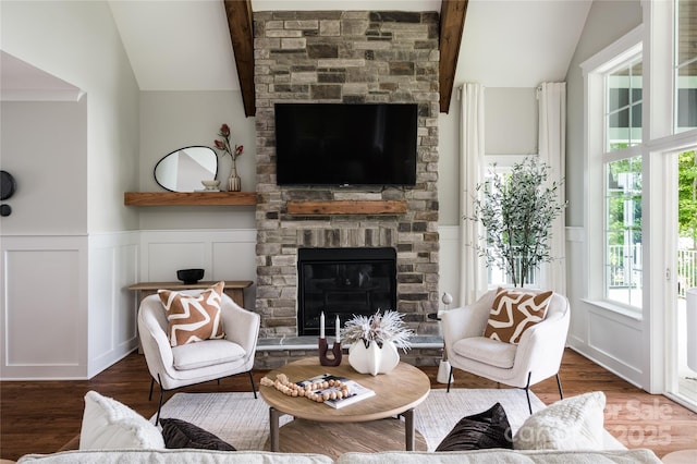434 Breezewood Dr, Belmont, NC 28012 - living room featuring vaulted ceiling, a decorative wall, wood finished floors, a fireplace, and a wainscoted wall
