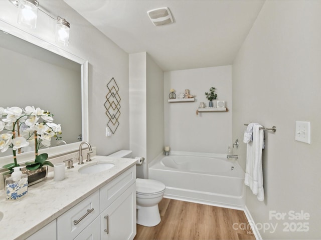 2005 Grimley Ln, Fort Mill, SC 29707 - bathroom featuring toilet, a garden tub, vanity, and wood finished floors