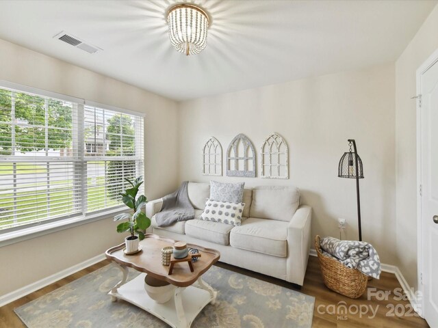 2005 Grimley Ln, Fort Mill, SC 29707 - living area featuring baseboards, wood finished floors, and a chandelier