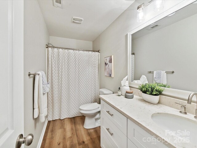 2005 Grimley Ln, Fort Mill, SC 29707 - bathroom with vanity, wood finished floors, toilet, and a shower with curtain
