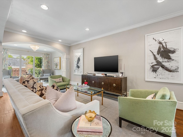 living room with arched walkways, crown molding, wood finished floors, and recessed lighting