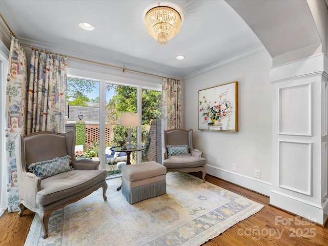 sitting room featuring crown molding, baseboards, a chandelier, wood finished floors, and recessed lighting