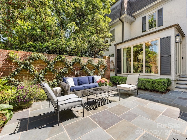 view of patio with an outdoor hangout area and fence