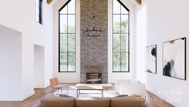 866 Concord Rd Unit 1C, Davidson, NC 28036 - living room with a towering ceiling, plenty of natural light, wood finished floors, a brick fireplace, and baseboards