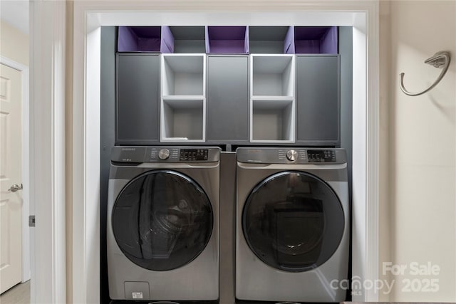 clothes washing area with washer and dryer
