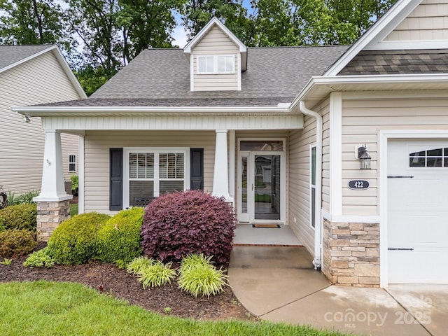 422 Drake Ln, Salisbury, NC 28146 - view of exterior entry featuring covered porch, roof with shingles, and an attached garage