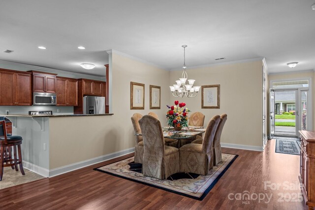 422 Drake Ln, Salisbury, NC 28146 - dining space with wood finished floors, baseboards, crown molding, a chandelier, and recessed lighting