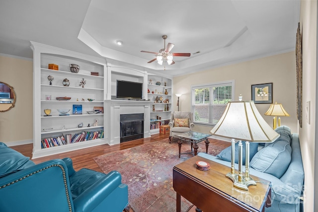 422 Drake Ln, Salisbury, NC 28146 - living room featuring a raised ceiling, a ceiling fan, wood finished floors, a fireplace, and crown molding