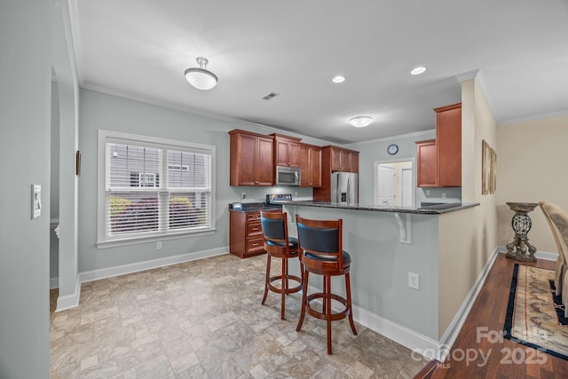 422 Drake Ln, Salisbury, NC 28146 - kitchen featuring stainless steel appliances, crown molding, a breakfast bar, baseboards, and a peninsula