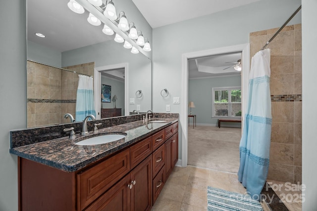422 Drake Ln, Salisbury, NC 28146 - full bathroom with a tile shower, double vanity, a ceiling fan, a tray ceiling, and baseboards