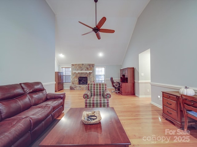 4620 Binwhe Ln, Gastonia, NC 28052 - living area with ceiling fan, a stone fireplace, light wood-style floors, high vaulted ceiling, and baseboards