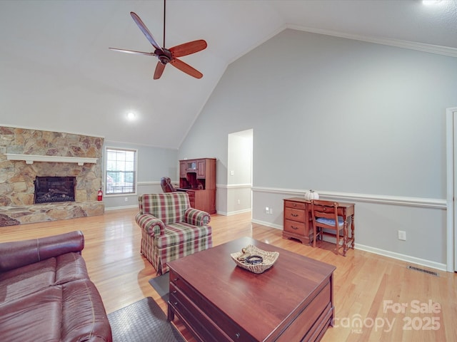 4620 Binwhe Ln, Gastonia, NC 28052 - living room featuring ceiling fan, light wood-type flooring, a stone fireplace, baseboards, and high vaulted ceiling