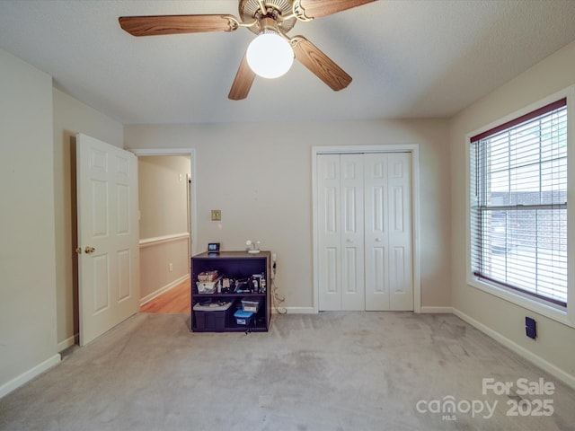 4620 Binwhe Ln, Gastonia, NC 28052 - unfurnished bedroom featuring carpet flooring, a closet, baseboards, and a ceiling fan