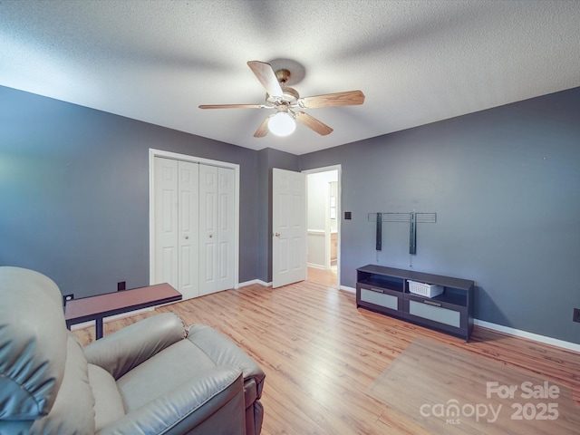 4620 Binwhe Ln, Gastonia, NC 28052 - living room featuring a ceiling fan, baseboards, wood finished floors, and a textured ceiling